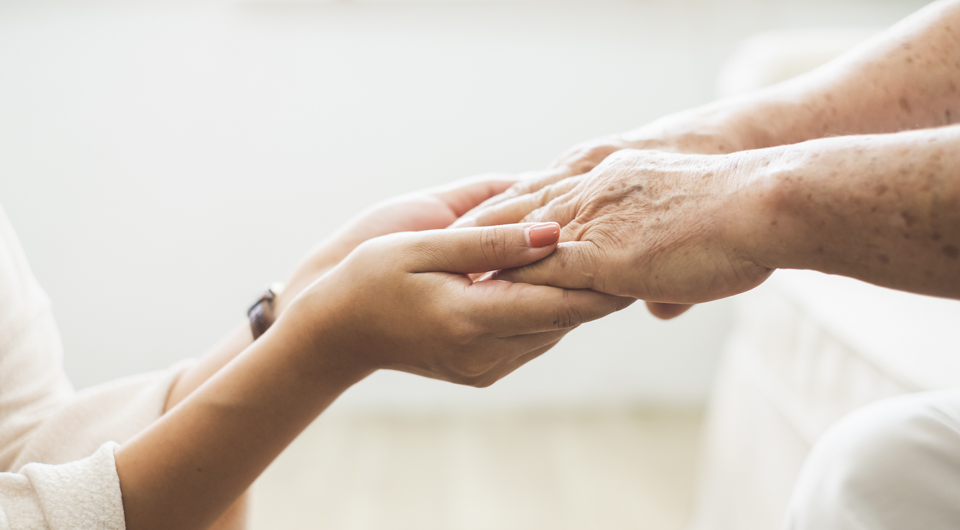 Caregiver holding an older adult's hands