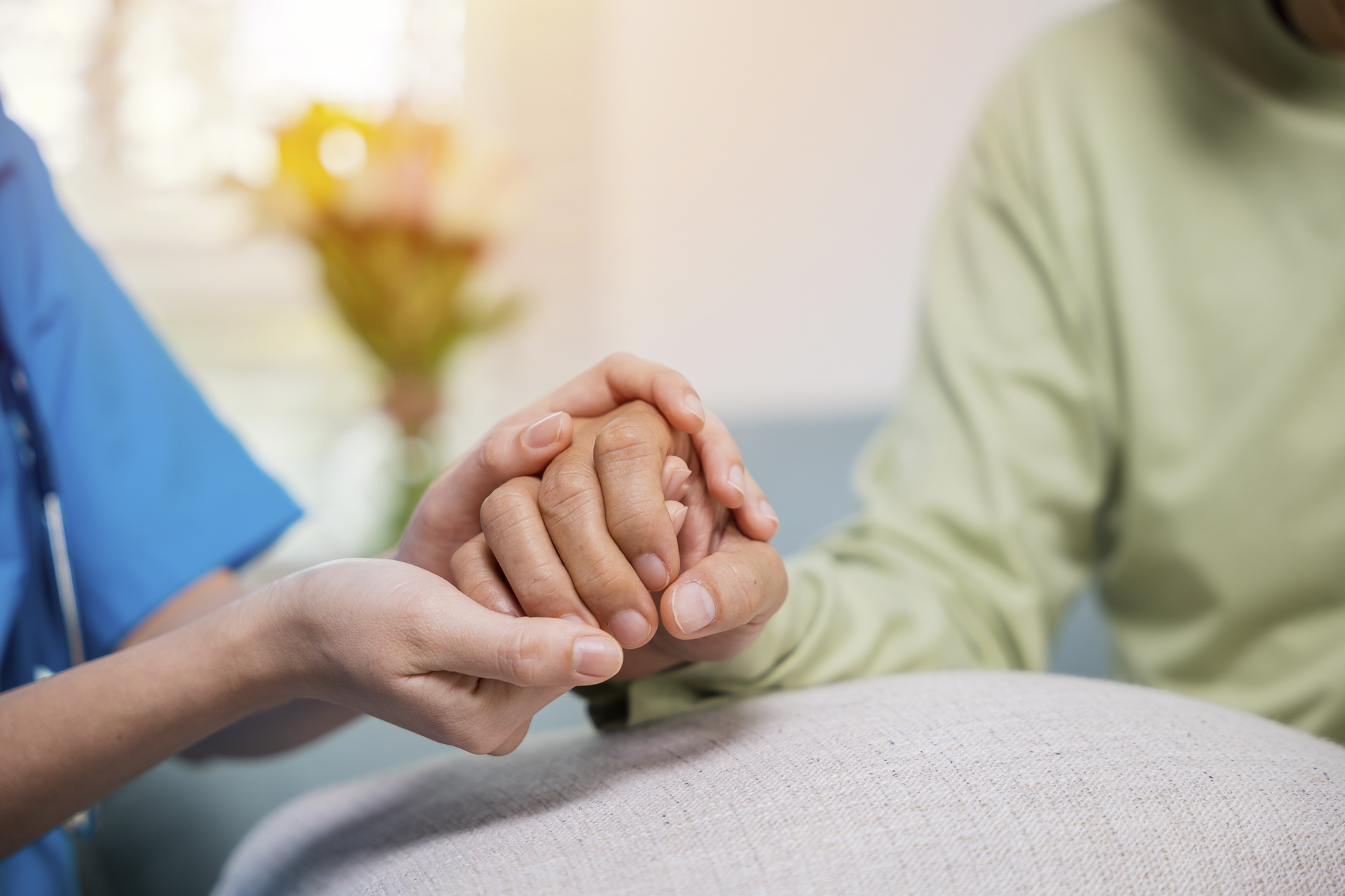 Hands held in a caring moment